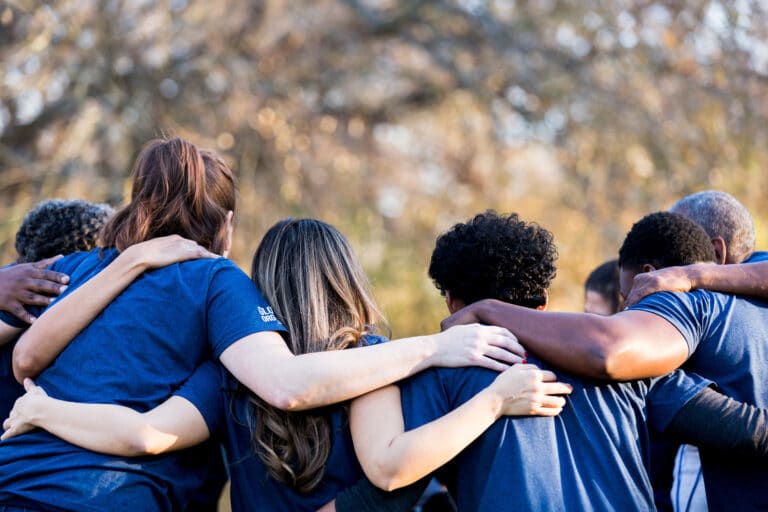 Friends linking arms in unity